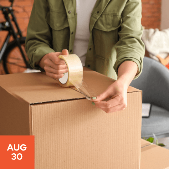 a person packing a box