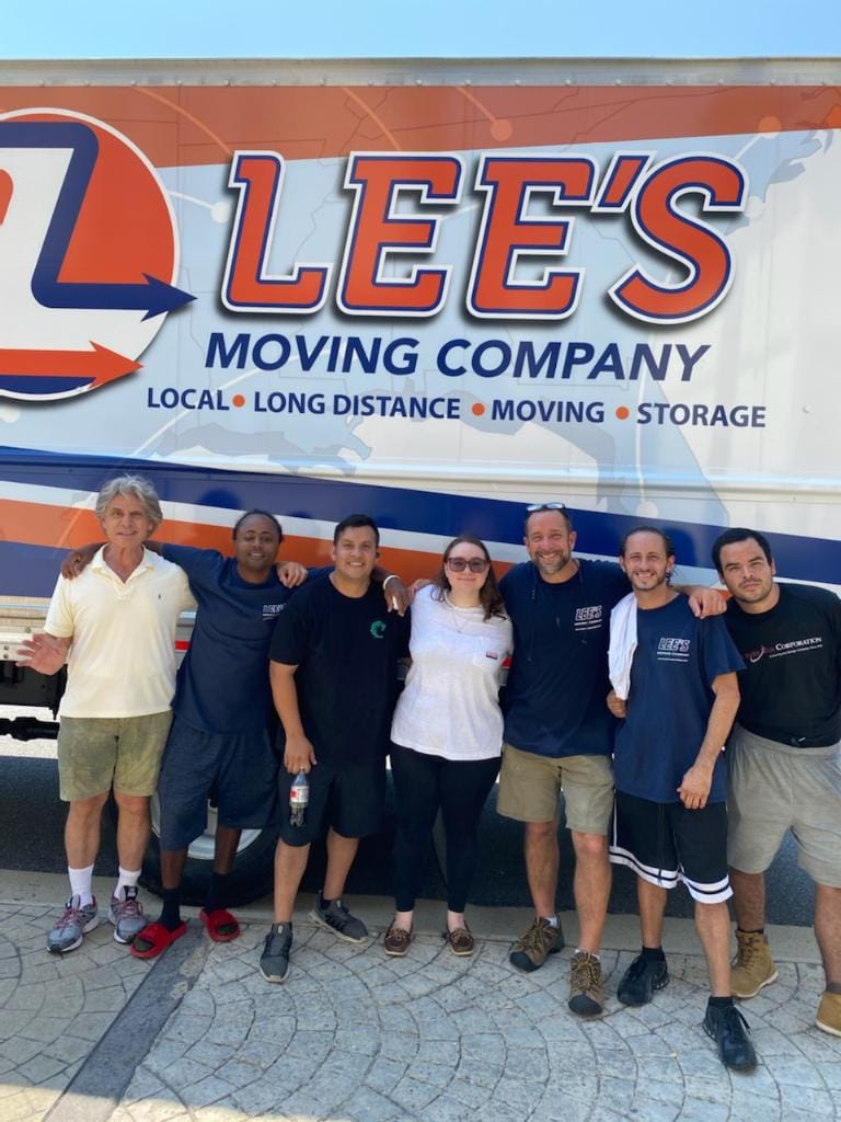 Lee's Moving Company crew standing in front of the moving truck, ready for a Lighthouse Point move