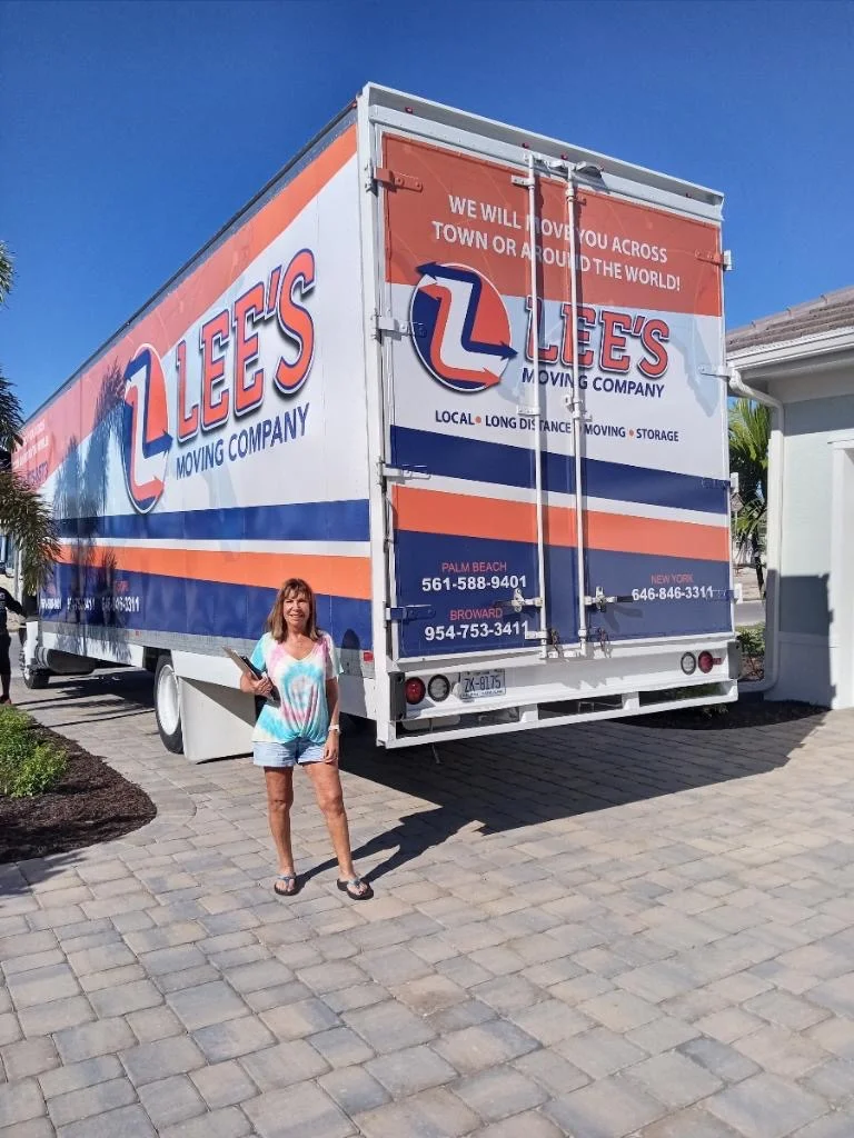 Happy customer in front of Lee's Moving truck, Boca Raton FL