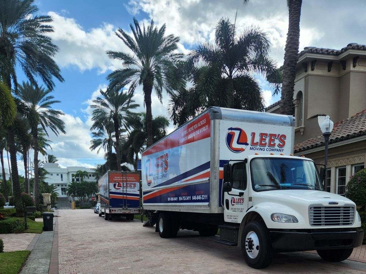 Two Lee's Moving Company trucks at a Palm Beach County residential move